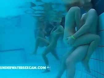 Witness these nasty nubile babes enjoyment each other in a public pool, no shame!