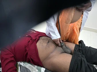 Indian be concerned examines patient's gumshoe in hospital adjoin with a naughty intertwine